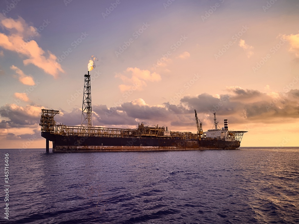 FPSO or floating product storage and offload at sea during sunset FPSO or floating product storage and offload at sea during sunset