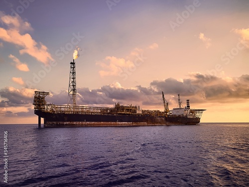 FPSO or  floating product storage and offload at sea during sunset 