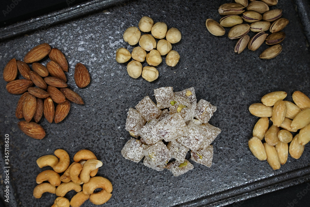 mixed nuts from above. Nuts of granite on a black background. Nuts shot from the top. nuts on a black background. peanut, cashew, roasted chickpea, hazelnut, pistachio, almond, roasted chickpea. mixed nuts from above. Nuts of granite on a black background. Nuts shot from the top. nuts on a black background. peanut, cashew, roasted chickpea, hazelnut, pistachio, almond, roasted chickpea.