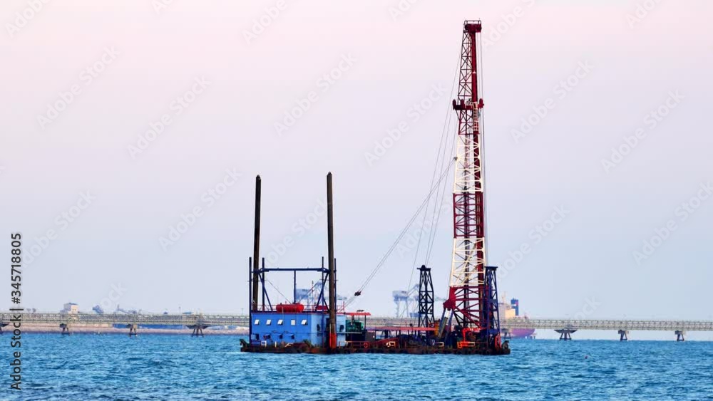 Buoy with crane Construction equipment floating in the bay Buoy with crane Construction equipment floating in the bay
