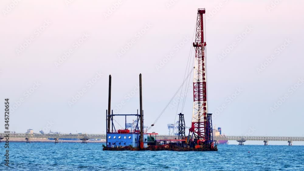 Buoy with crane Construction equipment floating in the bay Buoy with crane Construction equipment floating in the bay
