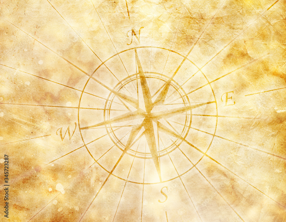 Old compass on paper background