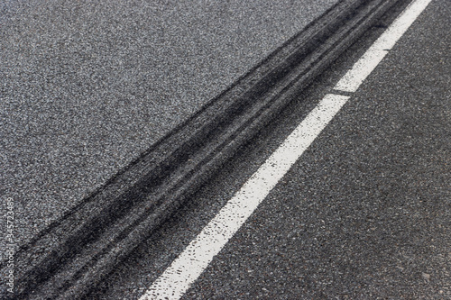 A burned rubber tire track on an asphalt road.