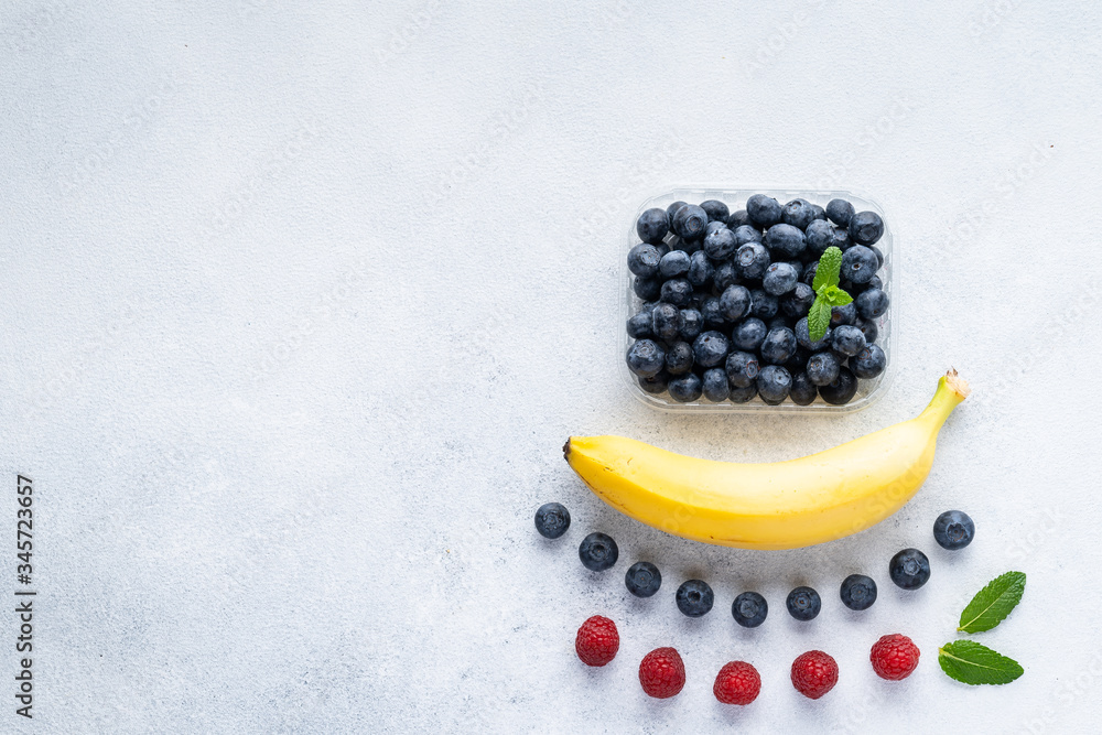 Healthy breakfast fruits and berry set on grey background. The concept of delicious and healthy food. Top view, copy space. Healthy breakfast fruits and berry set on grey background. The concept of delicious and healthy food. Top view, copy space.