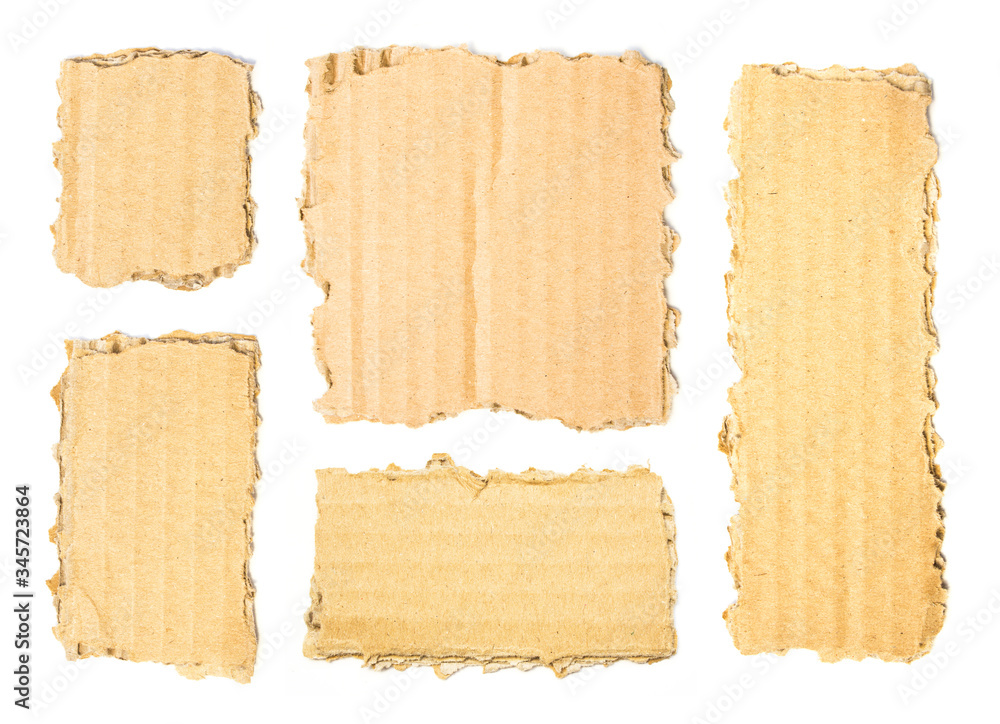 Set of brown torn pieces of corrugated cardboard isolated on white background. Ripped pieces of cardboard for advertising text.