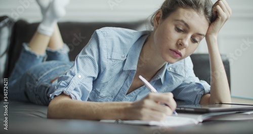 Young woman using digital tablet computer in home