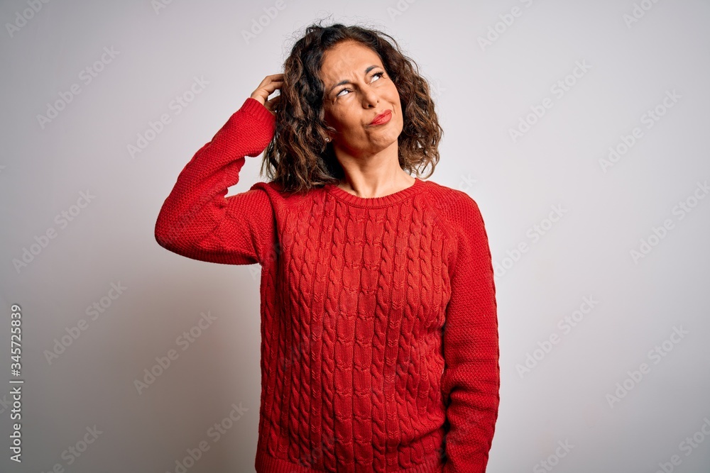 Middle age brunette woman wearing casual sweater standing over isolated white background confuse and wondering about question. Uncertain with doubt, thinking with hand on head. Pensive concept. Middle age brunette woman wearing casual sweater standing over isolated white background confuse and wondering about question. Uncertain with doubt, thinking with hand on head. Pensive concept.