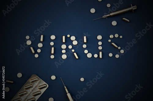 Gold tablets and syringes on a dark background.
