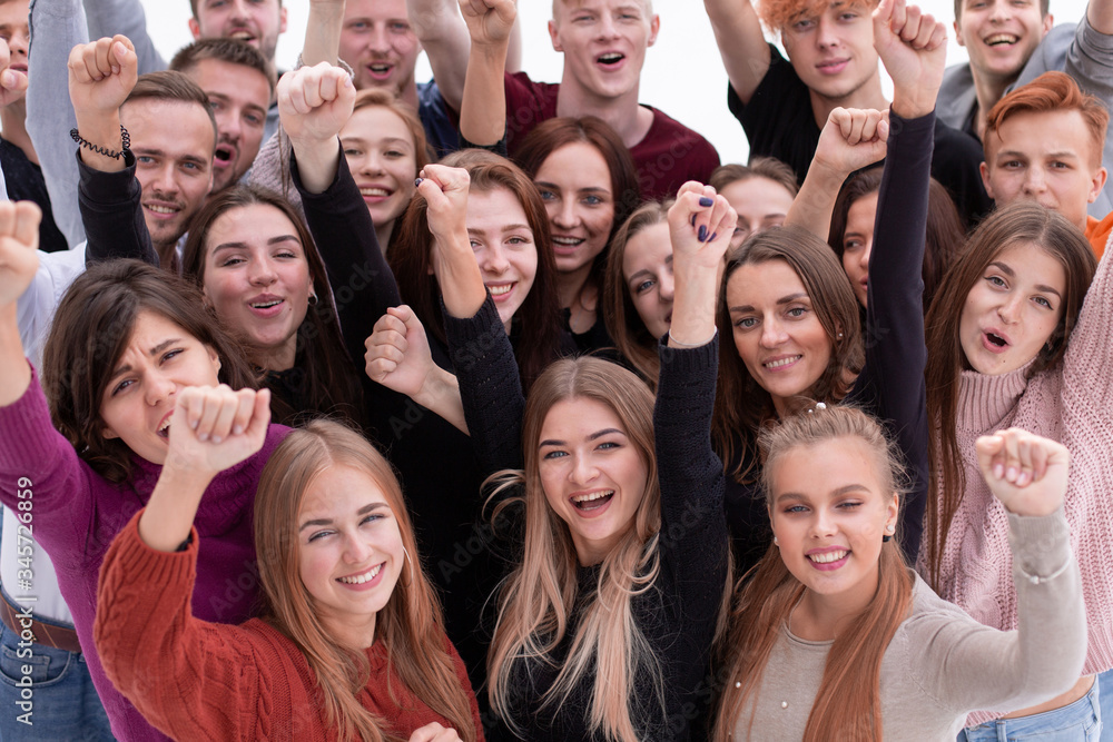 group of confident young people looking at the camera and showing their success group of confident young people looking at the camera and showing their success