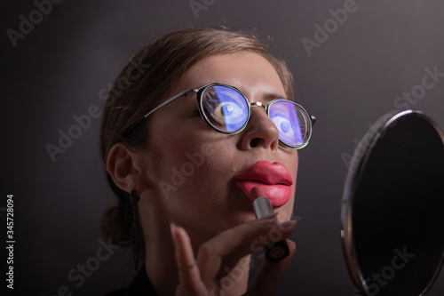 Tablou pe pânză Close-up of the young girl with plasticine make-up look in the mirror