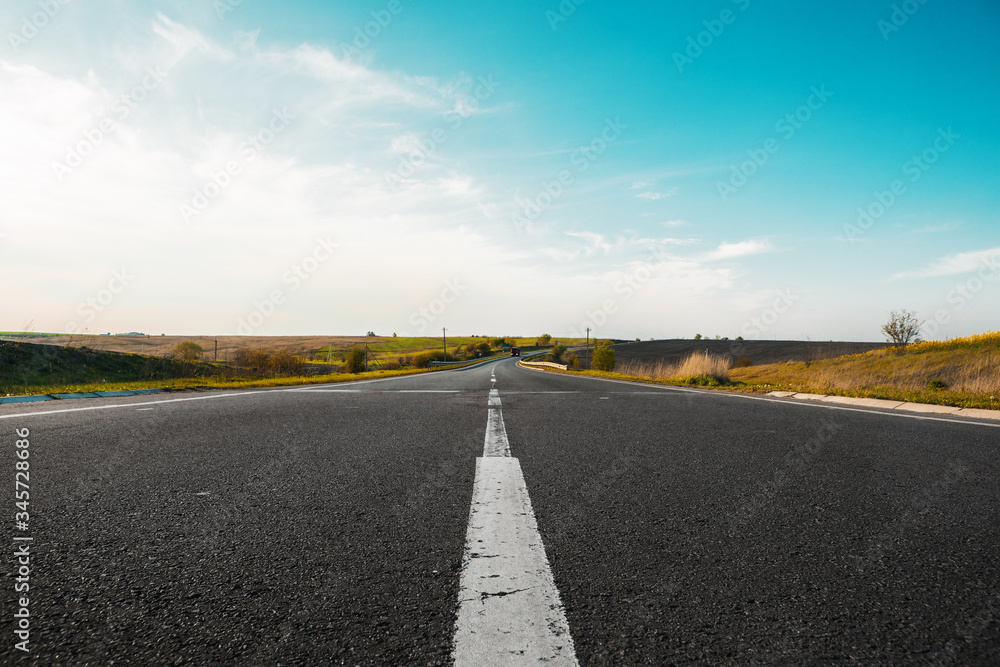 Fototapeta premium speed highway through the field. asphalt-paved road