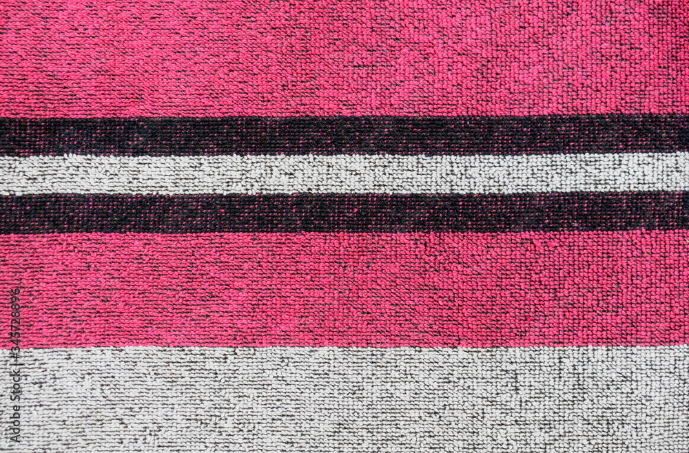 Striped terry towel in black, white and pink. Terry cloth texture closeup. Striped terry towel in black, white and pink. Terry cloth texture closeup.