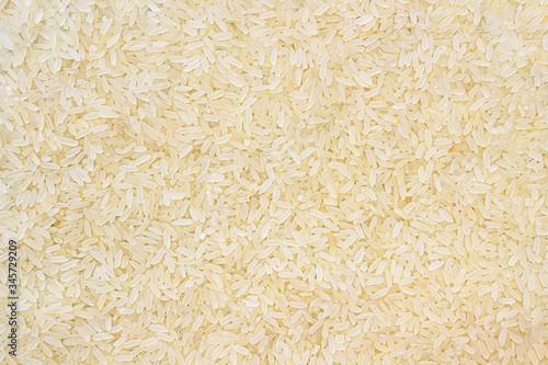 Layer of rice grits. Food background of long-grain rice.