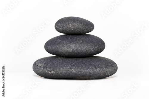 3 stones stacked one on top of the other in a pyramid shape keeping balance.