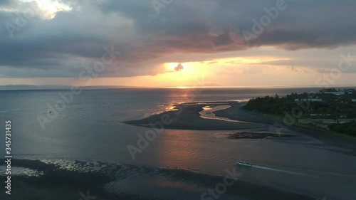 flying away from an epic sunset is seen floating fishing in the harbor of Prancak Perancak Peninsula bali indonesia photo