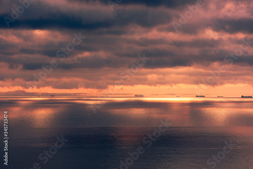 sunrise with beautiful clouds on the sea with ships