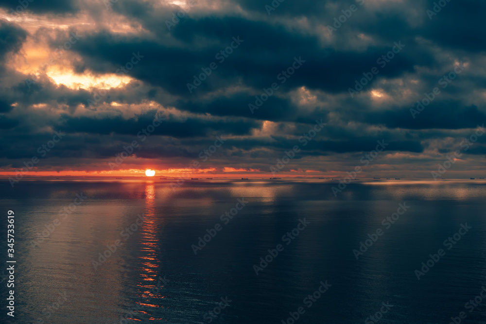 sunrise with beautiful clouds on the sea with ships