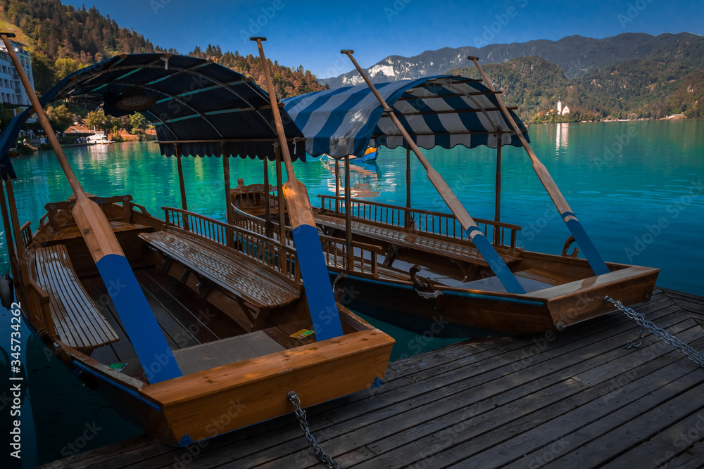 wooden boats on clear blue lake bled