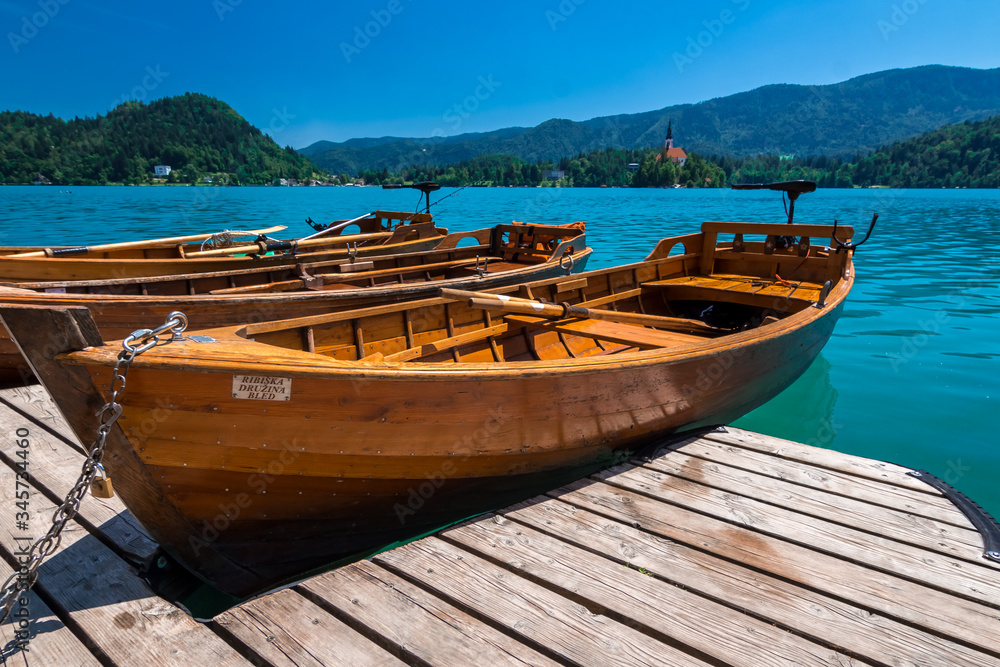 wooden boats on clear blue lake bled