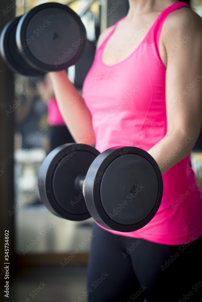 Thin thirties woman doing exercise in the gym Thin thirties woman doing exercise in the gym