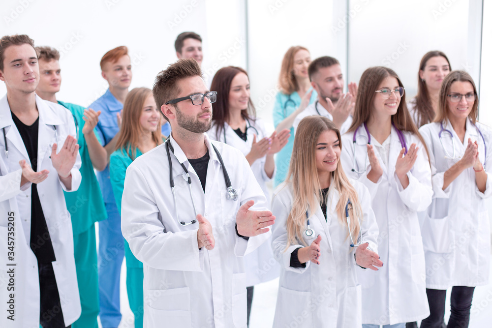 close up. confident doctors and interns standing together close up. confident doctors and interns standing together