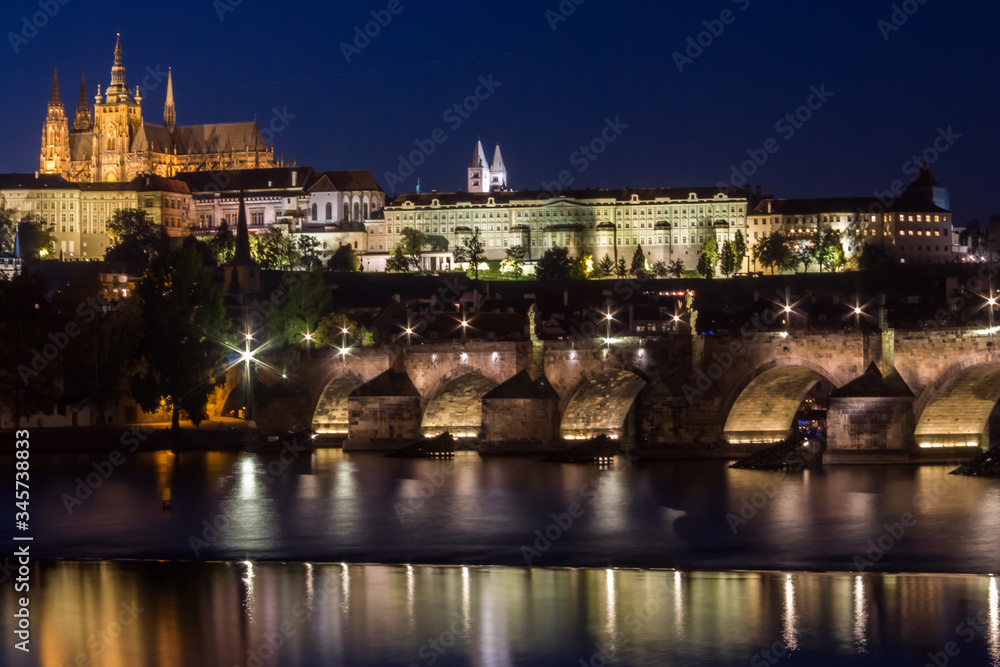 Prague Castle and Charles Bridge in night illumination, panoramic view of Prague.