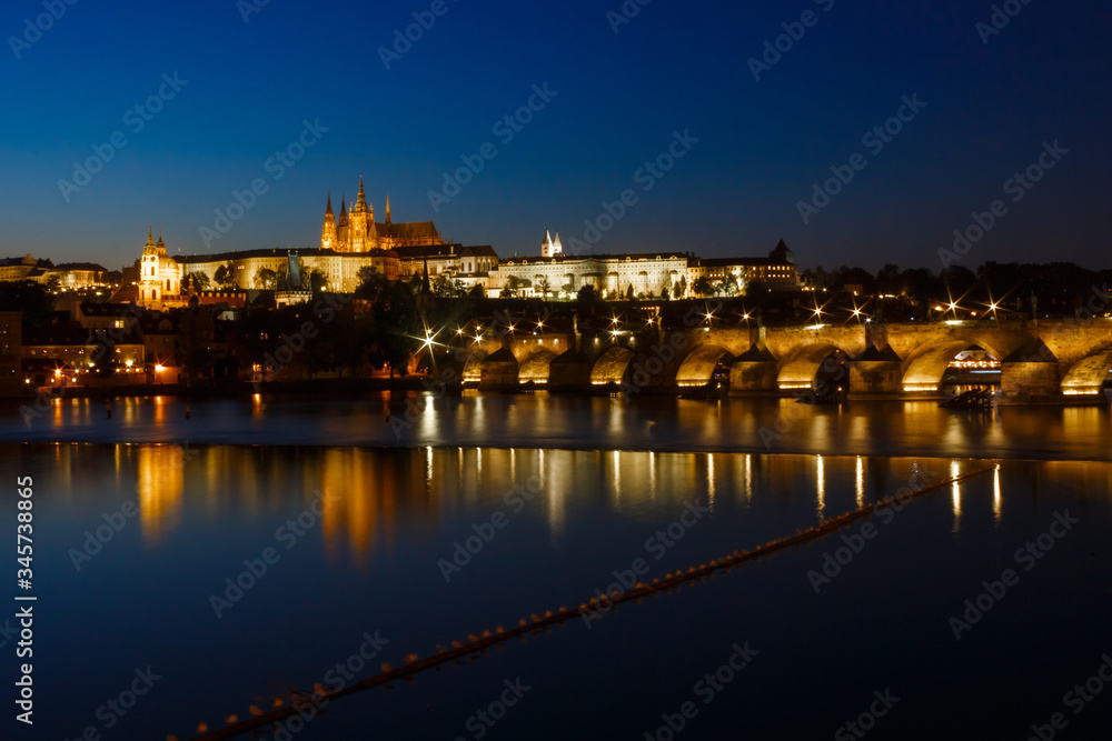 Prague Castle and Charles Bridge in night illumination, panoramic view of Prague.