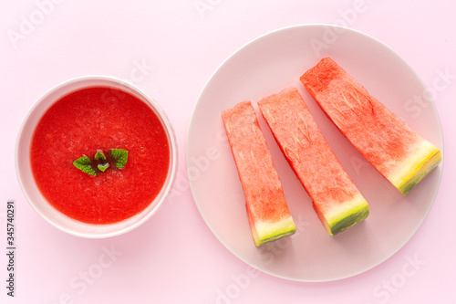 Fresh watermelon mint juice on pink background from above