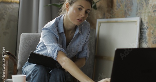 Young woman using digital tablet computer in home photo