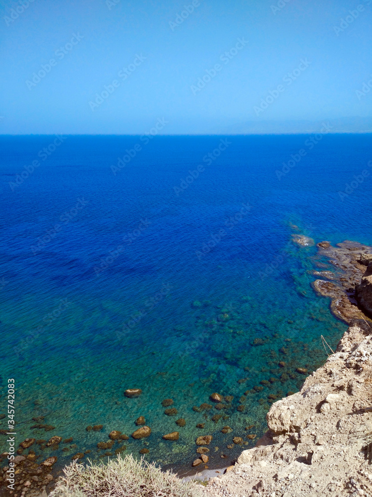 Blue-turquoise sea from the height of the mountain. Beautiful summer landscape.