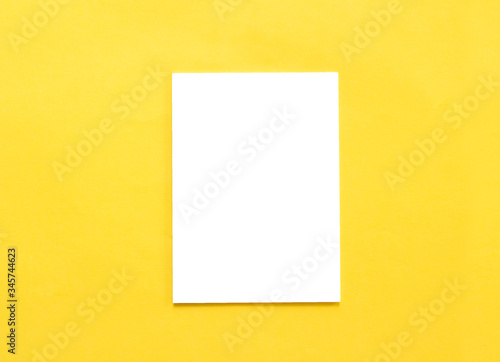 Blank paper on yellow background.