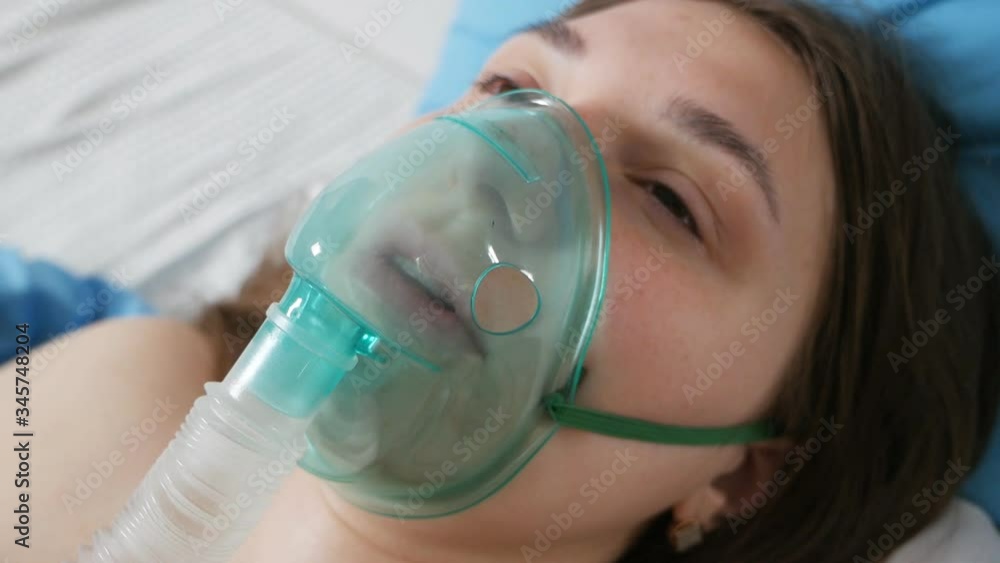 A patient with an oxygen mask in a hospital with a pandemic of the coronavirus Covid19