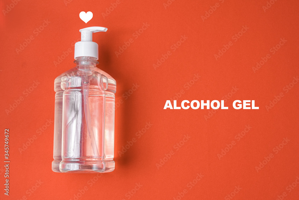 Container with alcohol gel on the red background Container with alcohol gel on the red background
