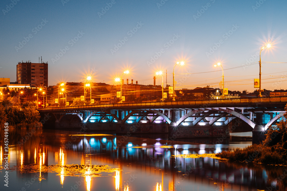 Vinnitsa, Ukraine. Panorama of beautiful city. Bridge and river on night city background. River on the background of urban evening lights.