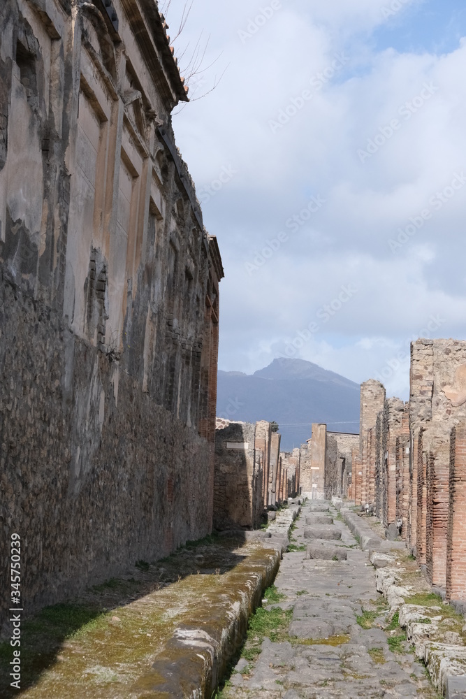 old street in an old town, the vesuvius in the background