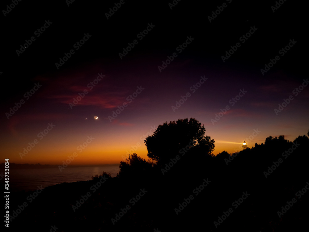 Fairytale sunset in the spotlights of lighthouse. Algarve, Portugal.