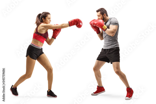 Man and woman in sportswear fighting with boxing gloves
