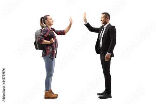 Female student gesturing high-five with a man in a suit