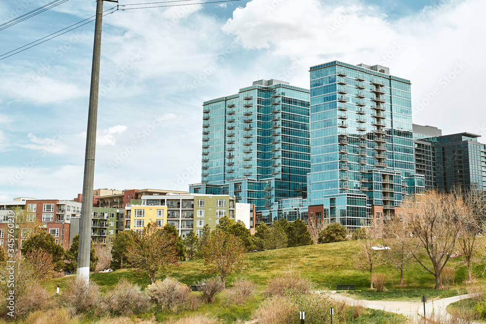 Landscape view of Commons Park with apartments and office buildings in the distance in lower Downtown Denver, Colorado