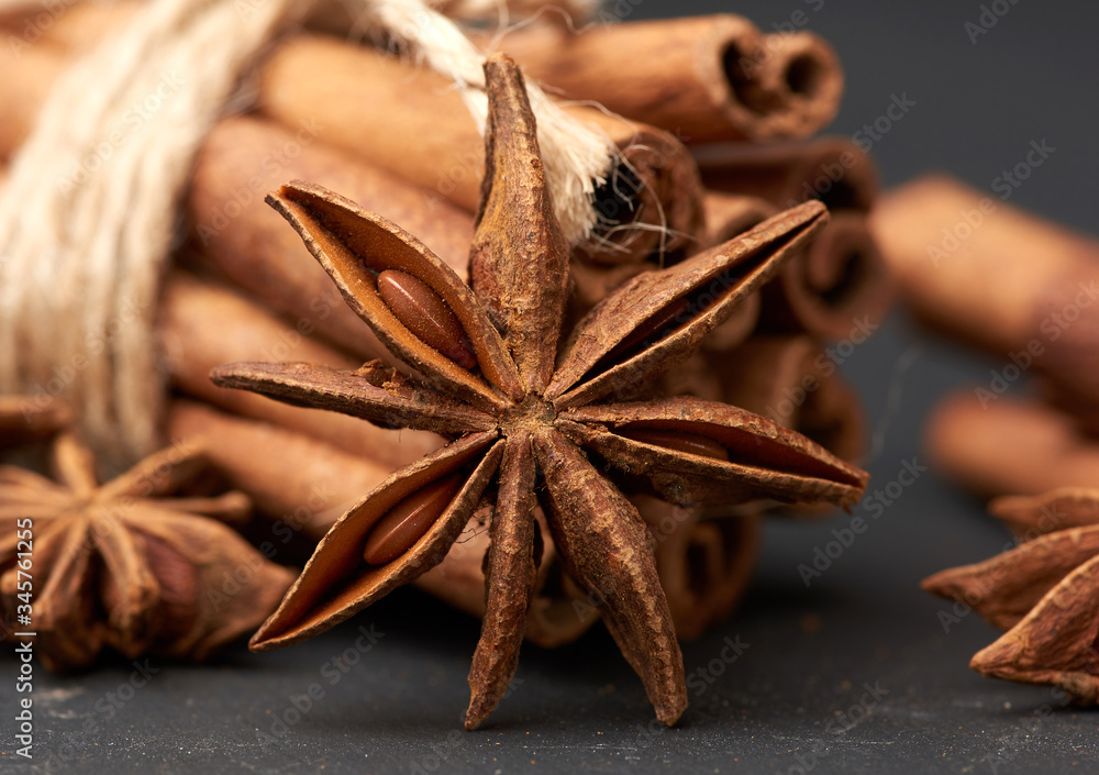 dry star anise with a bunch of brown cinnamon sticks tied with a rope dry star anise with a bunch of brown cinnamon sticks tied with a rope
