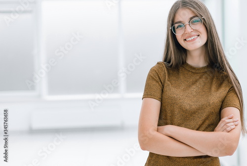 friendly young woman standing in spacious office