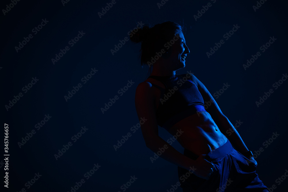 In neon blue lighting demonstrates relief external oblique abdominal muscles model on a dark blue background.