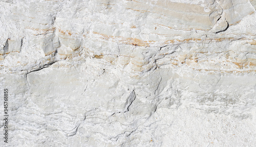 abstract texture of coastal white stone with red stripes for background, close-up