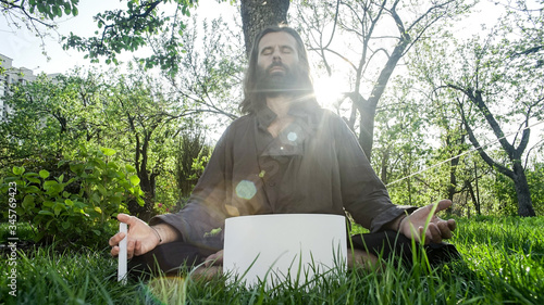 A qigong master conducts meditation using a gong and Crystal bowl, Crystal Tibetian singing bowl, a master meditates receives energy for the body photo