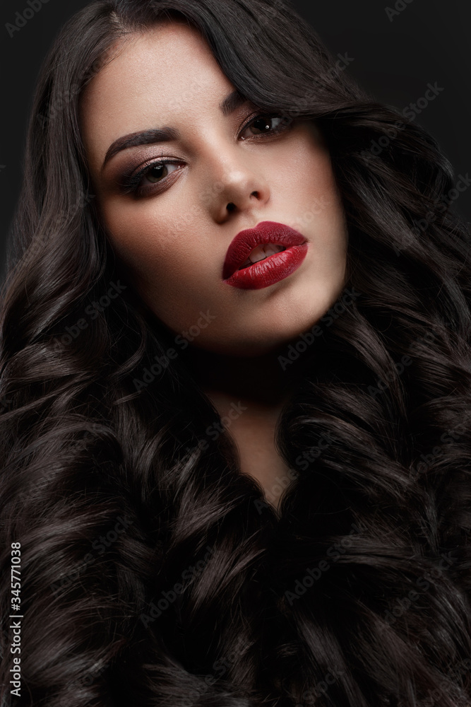 Beautiful brunette model: curls, classic makeup and red lips. The beauty face. Beautiful brunette model: curls, classic makeup and red lips. The beauty face.