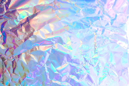 Abstract radiant festive backdrop texture image of holographic bokeh iridescent metallic foil