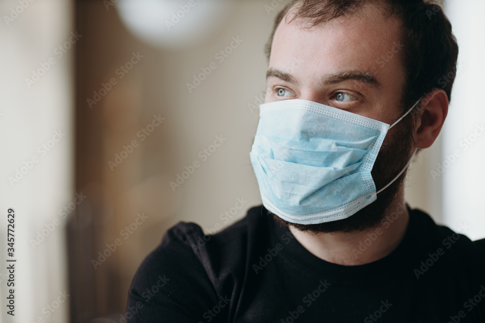 Portrait of man wearing a protective medical face mask to prevent infection of coronavirus.