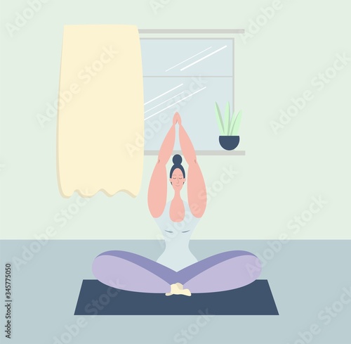 A woman meditates. A young girl meditates in the Lotus position. Yoga classes at home. Maintaining psychological health. Psychological balance. The positivity of the body.