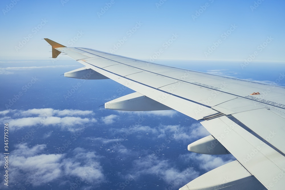 Cloudscape from window airplane, landscape of wing plane on a cloudy sky Cloudscape from window airplane, landscape of wing plane on a cloudy sky