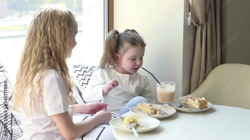 A friendly company of children in cafe with a delicious desserts. The day of the birth A friendly company of children in cafe with a delicious desserts. The day of the birth